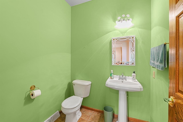 705 Red Fox, Fond Du Lac, WI 54937 - half bathroom featuring toilet, baseboards, a sink, and tile patterned floors