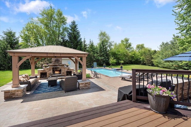 7197 Welford Pl, Sun Prairie, WI 53590 - wooden terrace featuring a gazebo, an outdoor living space with a fireplace, a patio, an outdoor pool, and view of scattered trees