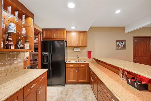 7197 Welford Pl, Sun Prairie, WI 53590 - kitchen with black refrigerator with ice dispenser, a sink, brown cabinetry, recessed lighting, and a peninsula