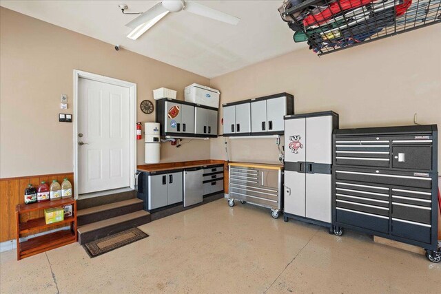 7197 Welford Pl, Sun Prairie, WI 53590 - garage with ceiling fan, wainscoting, and fridge