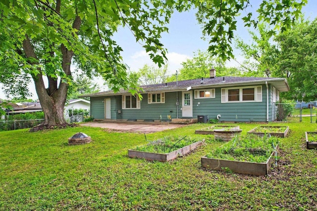 109 Cherry St, Edgerton, WI 53534 - rear view of property with a fire pit, a garden, a chimney, and a patio