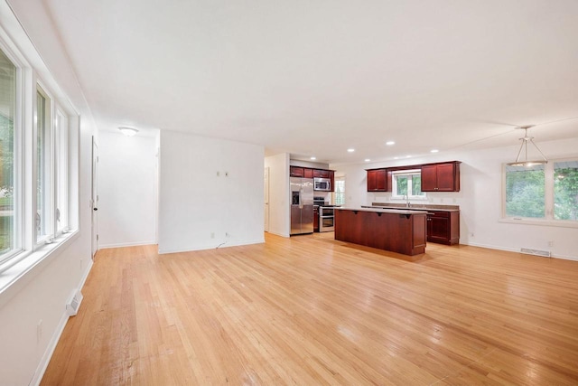 109 Cherry St, Edgerton, WI 53534 - unfurnished living room featuring light wood-style floors, baseboards, and recessed lighting