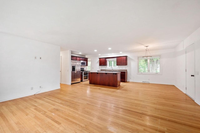 109 Cherry St, Edgerton, WI 53534 - kitchen with stainless steel appliances, open floor plan, a center island, light wood-style floors, and recessed lighting