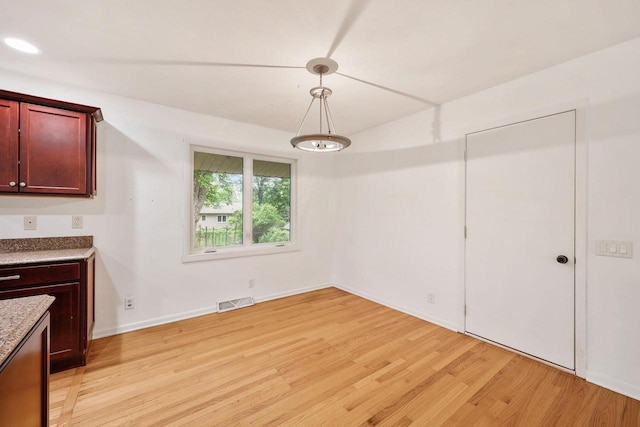 109 Cherry St, Edgerton, WI 53534 - unfurnished dining area featuring light wood-type flooring and baseboards
