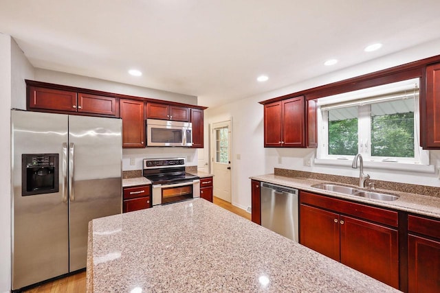 109 Cherry St, Edgerton, WI 53534 - kitchen featuring appliances with stainless steel finishes, a sink, dark brown cabinets, plenty of natural light, and recessed lighting