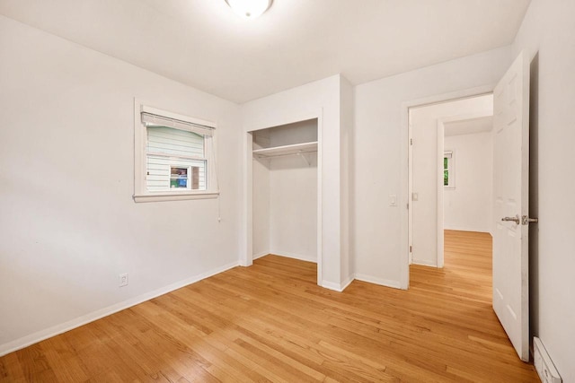 109 Cherry St, Edgerton, WI 53534 - unfurnished bedroom featuring light wood-style flooring, multiple windows, a closet, and baseboards
