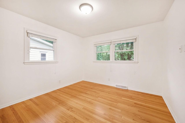 109 Cherry St, Edgerton, WI 53534 - empty room with plenty of natural light, light wood finished floors, and baseboards
