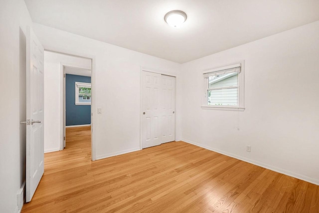 109 Cherry St, Edgerton, WI 53534 - unfurnished bedroom featuring light wood finished floors, baseboards, and multiple windows