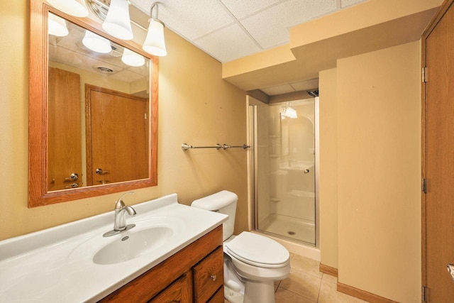 109 Cherry St, Edgerton, WI 53534 - full bath featuring toilet, a paneled ceiling, vanity, tile patterned flooring, and a stall shower
