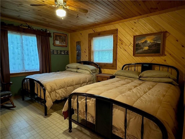 16199 W Musky Point Dr, Stone Lake, WI 54843 - bedroom with wooden walls, wood ceiling, tile patterned floors, and a ceiling fan