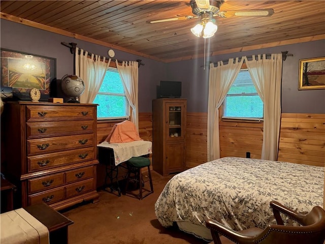16199 W Musky Point Dr, Stone Lake, WI 54843 - carpeted bedroom with multiple windows, wainscoting, wood ceiling, wood walls, and a ceiling fan
