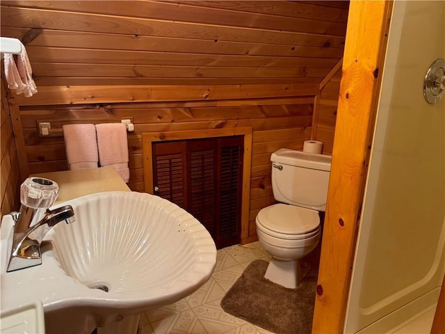 16199 W Musky Point Dr, Stone Lake, WI 54843 - bathroom featuring wood walls, toilet, and a sink