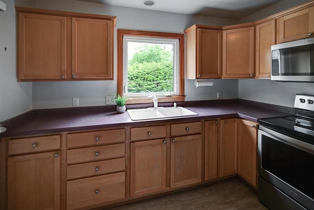 613 Anthony Ln, Madison, WI 53711 - kitchen with appliances with stainless steel finishes, a sink, dark countertops, and dark wood-style floors