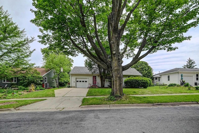 613 Anthony Ln, Madison, WI 53711 - obstructed view of property with driveway, a front lawn, and an attached garage