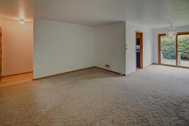 613 Anthony Ln, Madison, WI 53711 - unfurnished room with light carpet, baseboards, and a chandelier