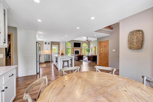 8373 Serenity Ln, Pulaski, WI 54162 - dining space featuring recessed lighting, dark wood-style flooring, and a fireplace