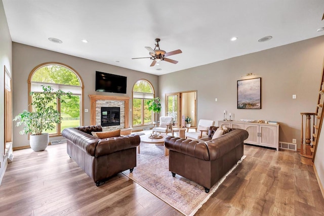 8373 Serenity Ln, Pulaski, WI 54162 - living room featuring ceiling fan, wood finished floors, a fireplace, recessed lighting, and baseboards