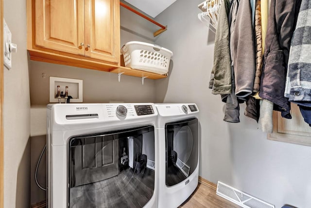 8373 Serenity Ln, Pulaski, WI 54162 - laundry room with washer and clothes dryer, wood finished floors, cabinet space, and baseboards