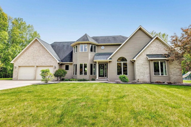 8373 Serenity Ln, Pulaski, WI 54162 - view of front facade featuring concrete driveway, a front lawn, an attached garage, roof with shingles, and brick siding