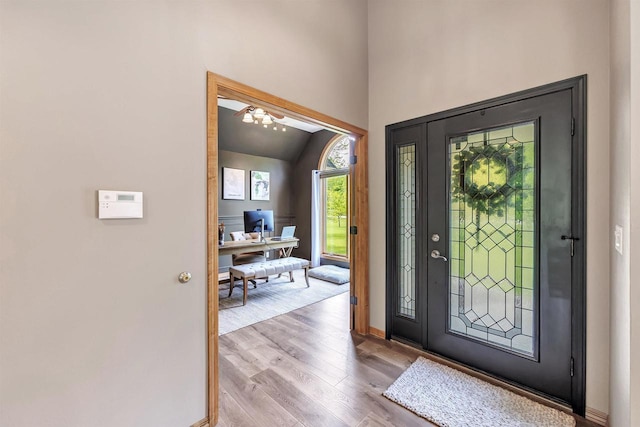 8373 Serenity Ln, Pulaski, WI 54162 - entryway featuring wood finished floors, vaulted ceiling, baseboards, and ceiling fan