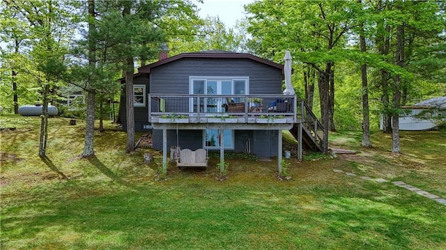 N5757 Division Ave, Stone Lake, WI 54876 - back of property featuring a chimney, stairs, a deck, and a lawn