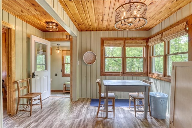 N5757 Division Ave, Stone Lake, WI 54876 - dining room featuring wood ceiling, wood finished floors, healthy amount of natural light, a chandelier, and wooden walls