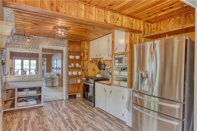 N5757 Division Ave, Stone Lake, WI 54876 - kitchen with appliances with stainless steel finishes, wooden ceiling, white cabinetry, wood walls, and light wood-style flooring