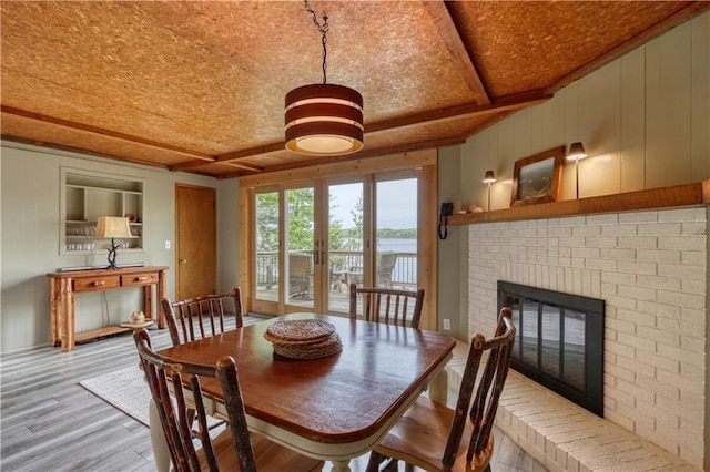 N5757 Division Ave, Stone Lake, WI 54876 - dining room with wood finished floors, a brick fireplace, and beam ceiling