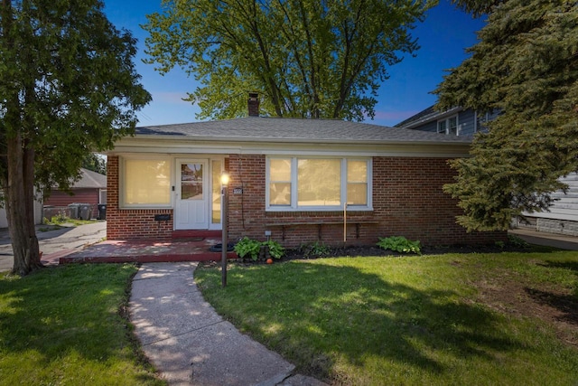 3559 E Van Norman Ave, Cudahy, WI 53110 - view of front facade with brick siding, a lawn, and a chimney