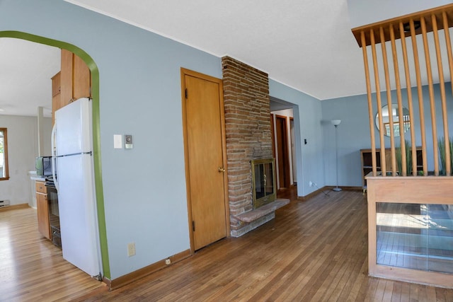 3559 E Van Norman Ave, Cudahy, WI 53110 - unfurnished living room with light wood-style floors, a fireplace, and baseboards