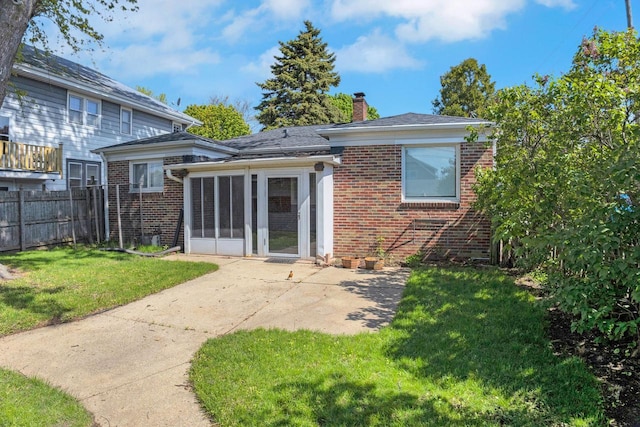 3559 E Van Norman Ave, Cudahy, WI 53110 - rear view of property with brick siding, a patio area, a chimney, and a sunroom