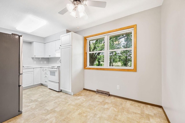 530 Dapin Rd, Madison, WI 53704 - kitchen with freestanding refrigerator, white range with electric cooktop, white cabinetry, a ceiling fan, and light countertops