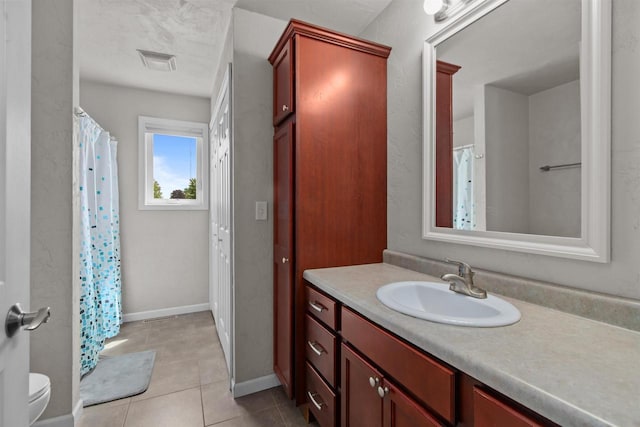 1308 Lavender Ln, Appleton, WI 54915 - full bath with vanity, tile patterned floors, toilet, a shower with shower curtain, and baseboards