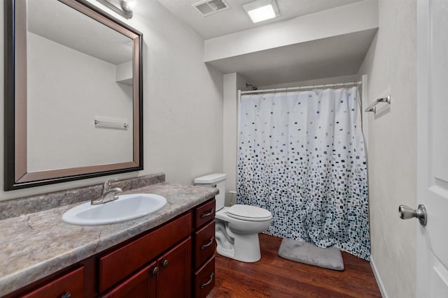 1308 Lavender Ln, Appleton, WI 54915 - full bathroom featuring wood finished floors, vanity, toilet, and a shower with shower curtain