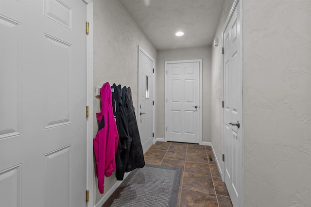 1308 Lavender Ln, Appleton, WI 54915 - doorway featuring baseboards, a textured wall, and stone finish floors