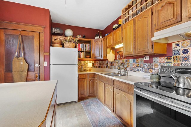 224 E Atlantic St, Appleton, WI 54911 - kitchen with electric range, freestanding refrigerator, a sink, under cabinet range hood, and light countertops
