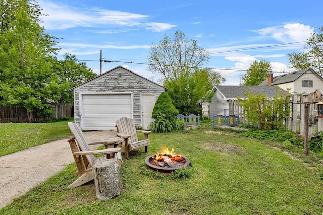 224 E Atlantic St, Appleton, WI 54911 - view of yard featuring an outdoor fire pit, a detached garage, driveway, and an outdoor structure