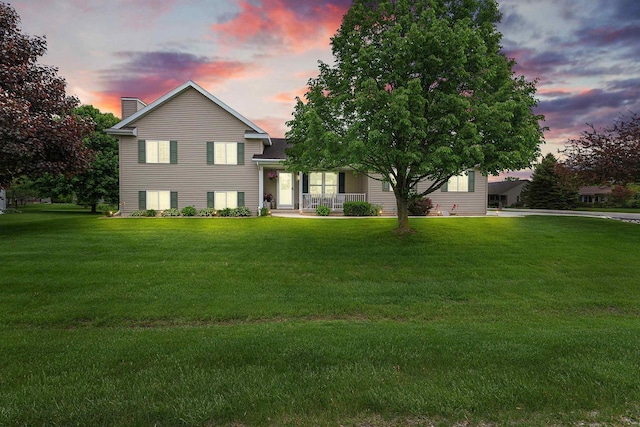 W7009 Crestwood Ln, Fond Du Lac, WI 54937 - view of front of house featuring a chimney, a lawn, and a porch