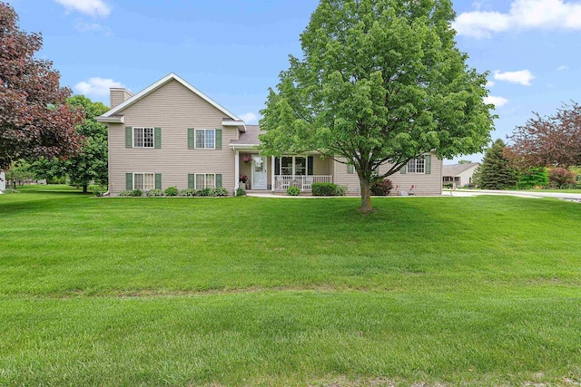 W7009 Crestwood Ln, Fond Du Lac, WI 54937 - tri-level home featuring a chimney, a front yard, and a porch
