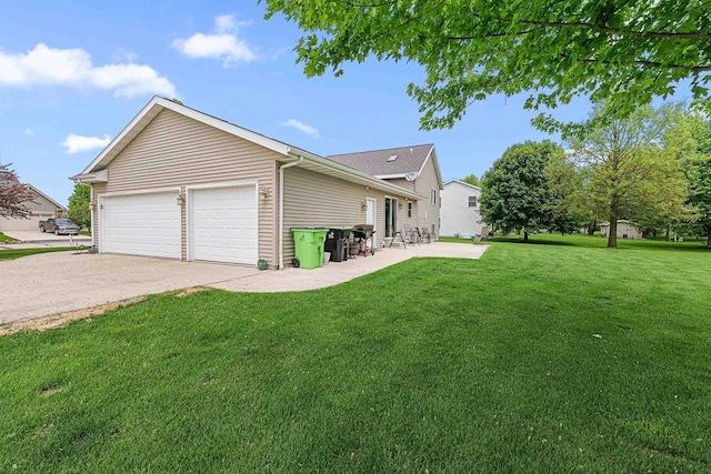 W7009 Crestwood Ln, Fond Du Lac, WI 54937 - rear view of house featuring a lawn, an attached garage, and a patio area