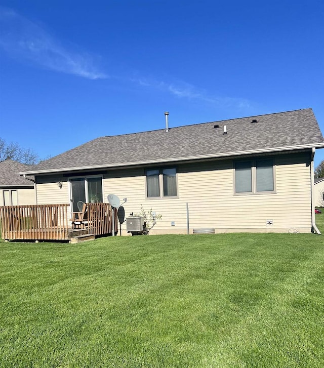 2335 Granite Ter Unit 32, Beloit, WI 53511 - rear view of house featuring a wooden deck, a yard, and roof with shingles