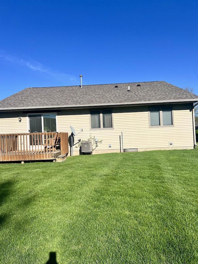 2335 Granite Ter Unit 32, Beloit, WI 53511 - rear view of house with a lawn, a shingled roof, and a deck