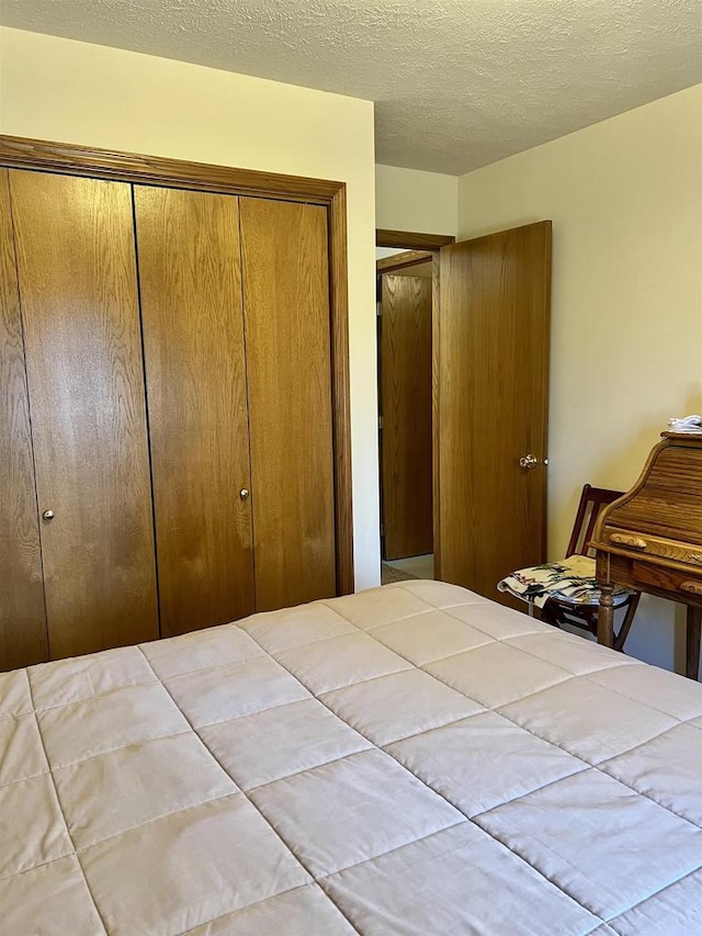 2335 Granite Ter Unit 32, Beloit, WI 53511 - bedroom with a closet and a textured ceiling