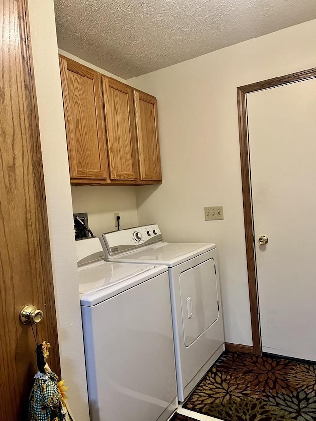 2335 Granite Ter Unit 32, Beloit, WI 53511 - laundry area with washer and dryer, cabinet space, and a textured ceiling