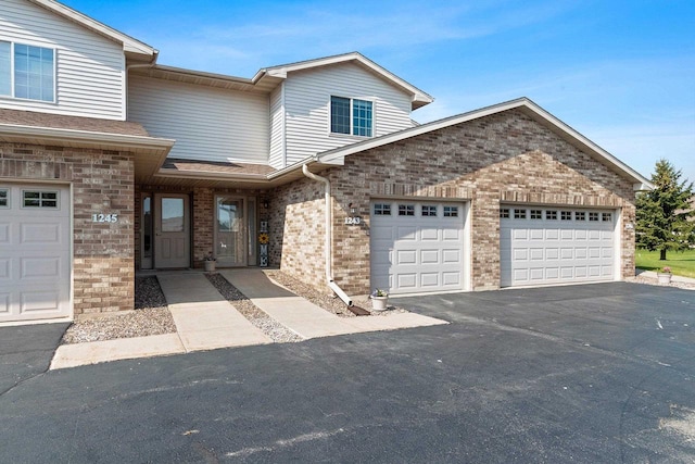1243 Pond View Cir, De Pere, WI 54115 - view of front of property featuring an attached garage, driveway, and brick siding