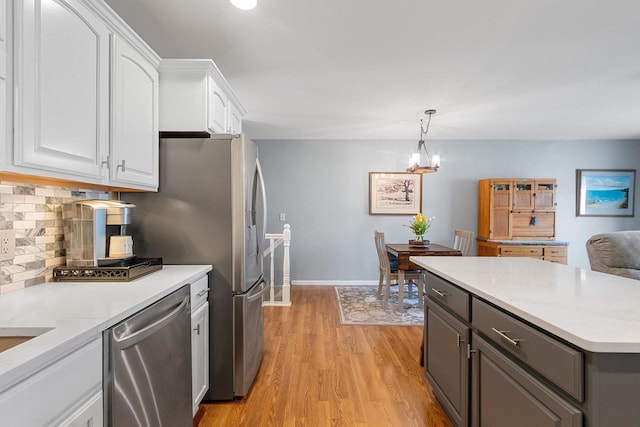 1243 Pond View Cir, De Pere, WI 54115 - kitchen featuring dishwasher, white cabinets, decorative backsplash, light wood finished floors, and a chandelier
