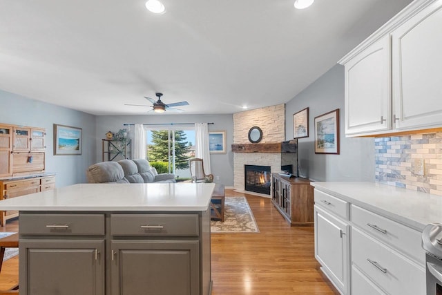 1243 Pond View Cir, De Pere, WI 54115 - kitchen with gray cabinets, open floor plan, white cabinetry, light wood-style floors, and backsplash