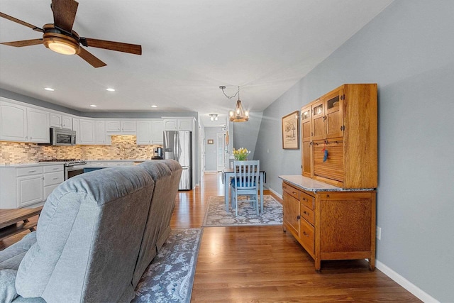 1243 Pond View Cir, De Pere, WI 54115 - living room featuring ceiling fan, baseboards, wood finished floors, a chandelier, and recessed lighting