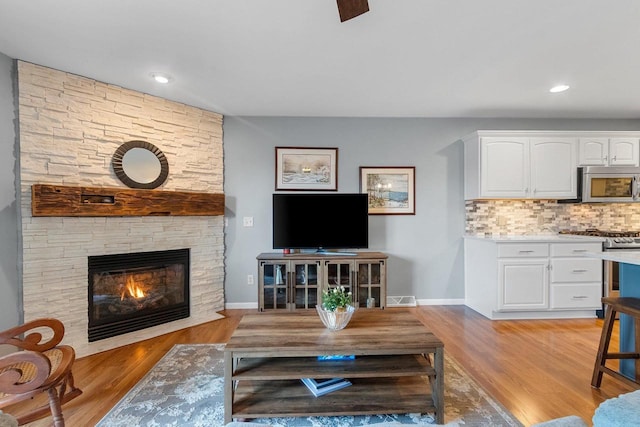 1243 Pond View Cir, De Pere, WI 54115 - living area featuring light wood finished floors, a fireplace, baseboards, and recessed lighting