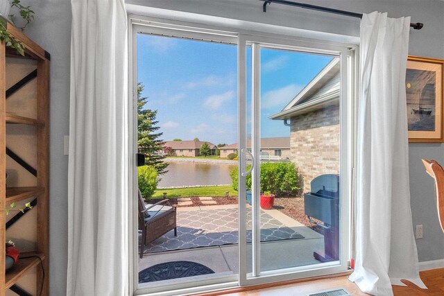 1243 Pond View Cir, De Pere, WI 54115 - doorway to outside featuring a water view and baseboards